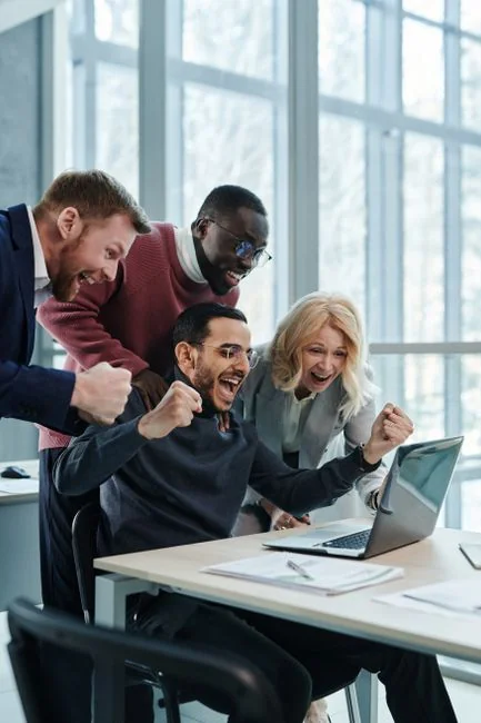 Diverse group of women working together in a modern office setting, fostering teamwork and creativity.